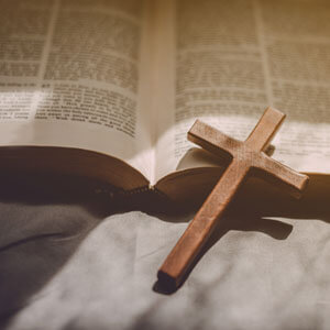 Crucifixion Of Jesus Christ ,cross With The Holy Bible At Sunlig